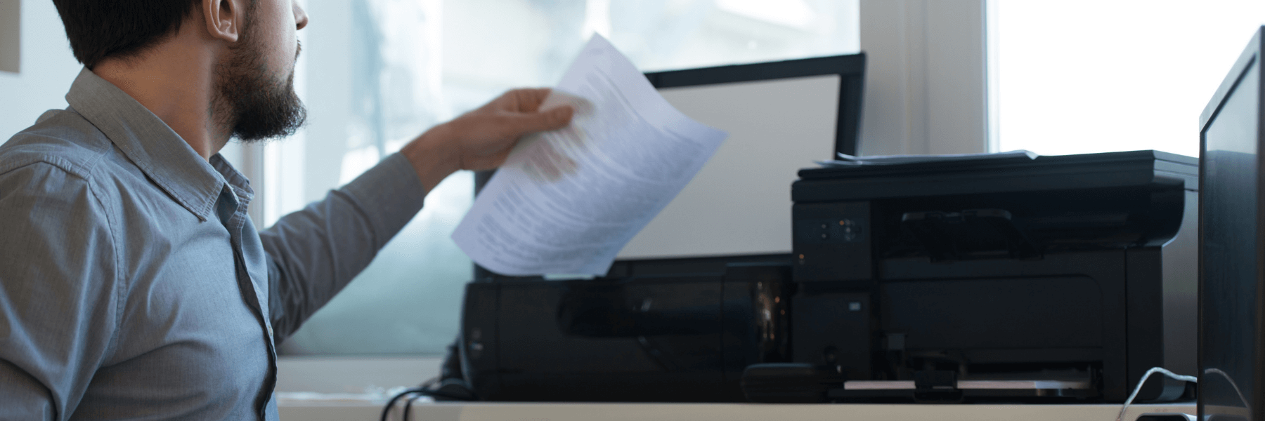 man using a network printer in his office