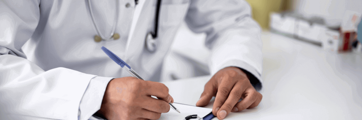 doctor writing on clipboard wearing stethoscope around neck